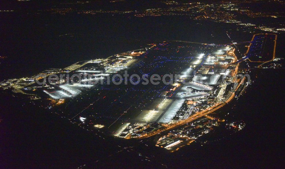 Aerial image at night Frankfurt am Main - Night lighting runway with hangar taxiways and terminals on the grounds of the airport in Frankfurt in the state Hesse, Germany