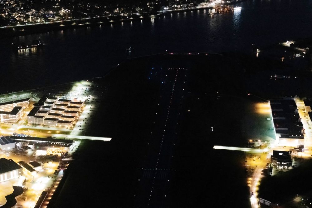 Aerial photograph at night Hamburg - Night lighting runway with hangar taxiways and terminals on the grounds of the airport in the district Finkenwerder in Hamburg, Germany