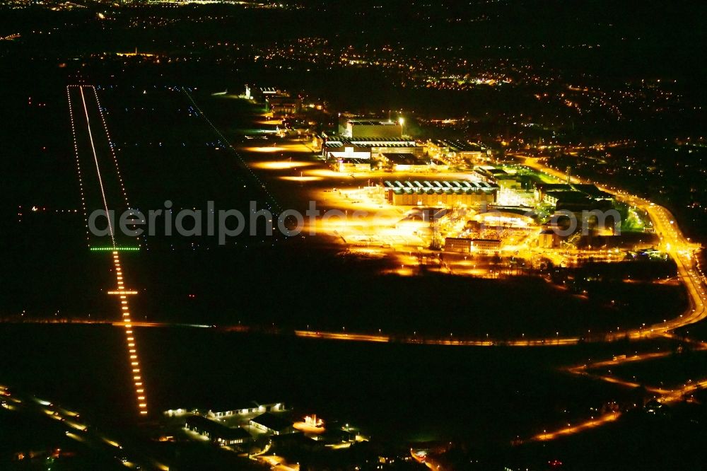 Dresden at night from above - Night lighting Runway with hangar taxiways and terminals on the grounds of the airport in the district Klotzsche in Dresden in the state Saxony, Germany