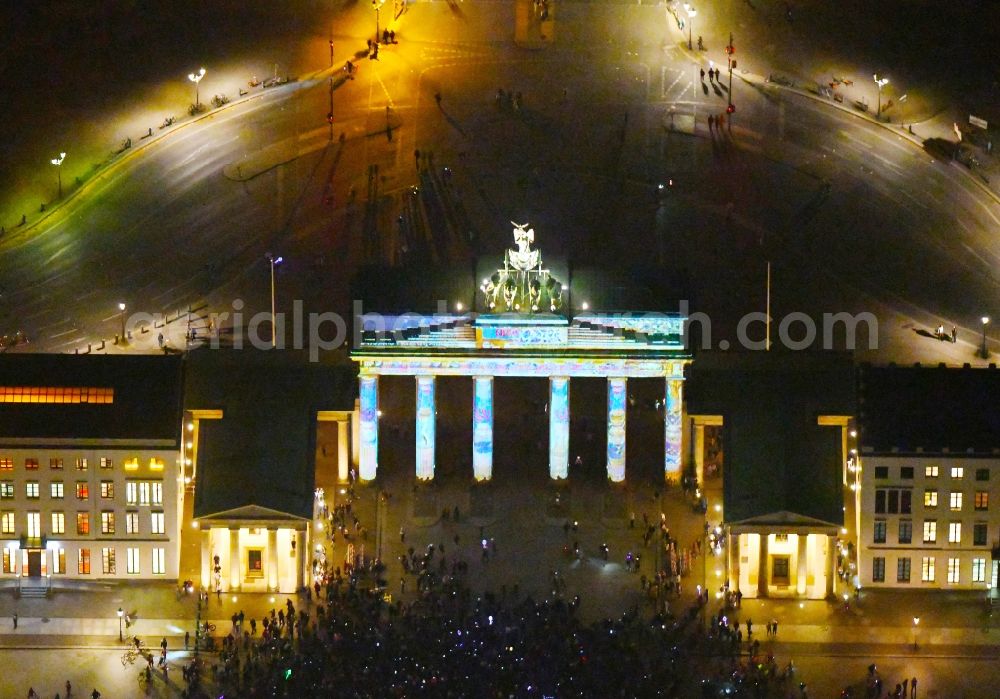 Aerial image at night Berlin - Night lighting Tourist attraction of the historic monument Brandenburger Tor on Pariser Platz - Unter den Linden in the district Mitte in Berlin, Germany