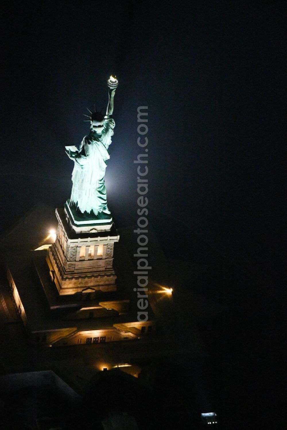 New York at night from above - Night lighting Tourist attraction of the historic monument Freiheitsstatue - Statue of Liberty National Monument in the district Manhattan in New York in United States of America