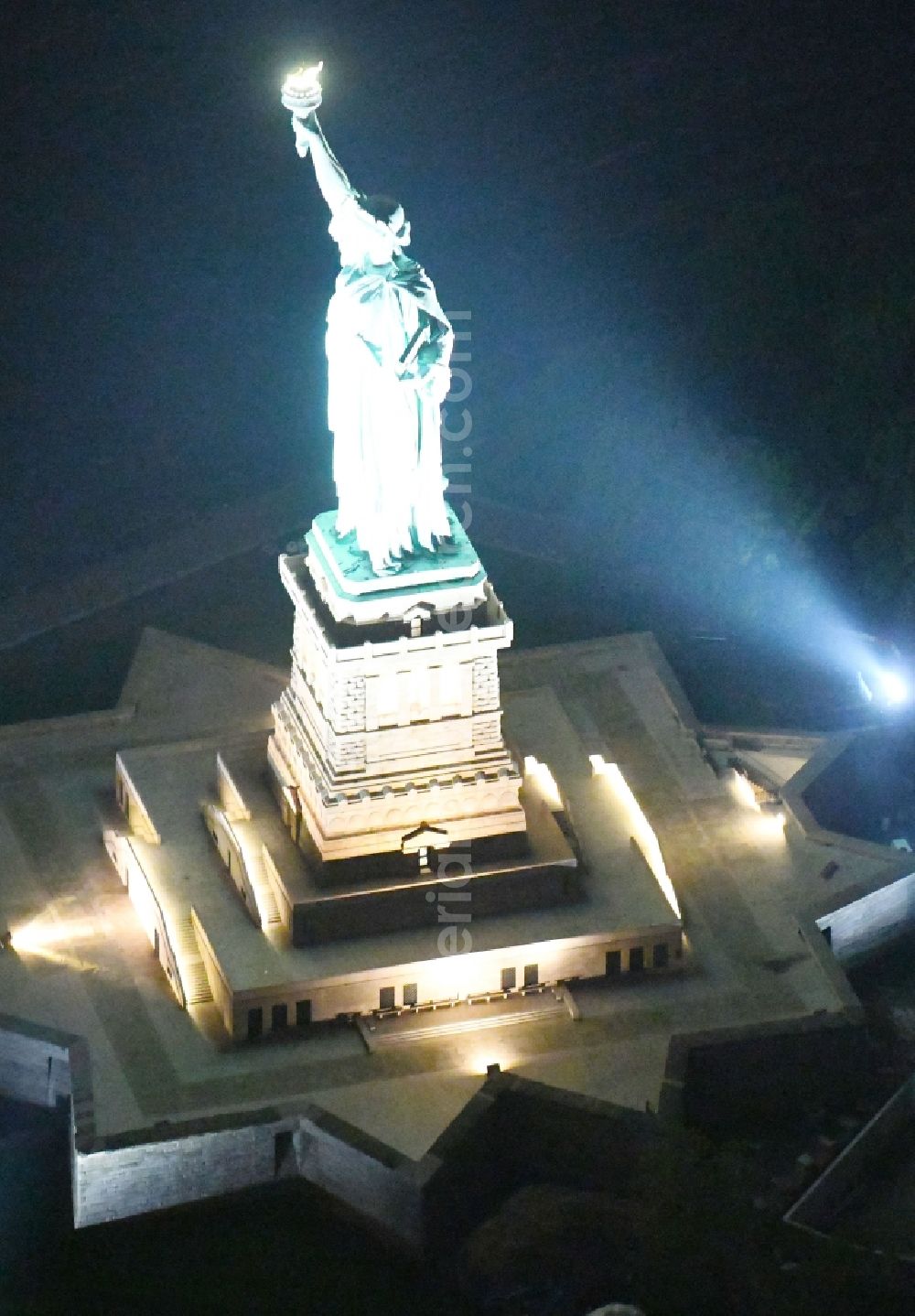 Aerial photograph at night New York - Night lighting Tourist attraction of the historic monument Freiheitsstatue - Statue of Liberty National Monument in the district Manhattan in New York in United States of America
