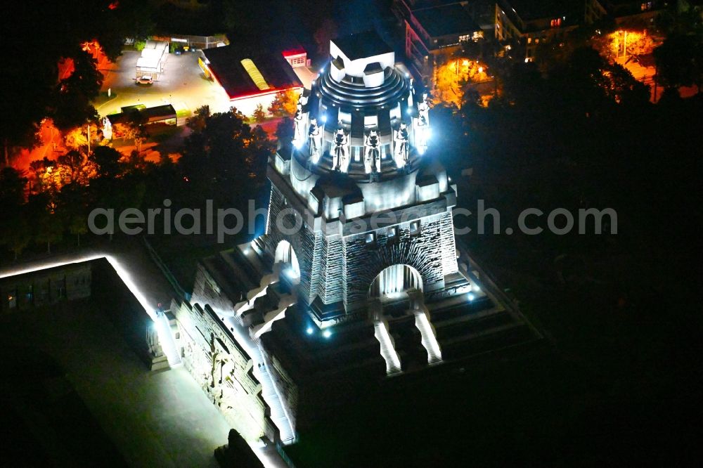 Aerial image at night Leipzig - Night lighting Tourist attraction of the historic monument Voelkerschlachtdenkmal on Strasse of 18. Oktober in Leipzig in the state Saxony, Germany