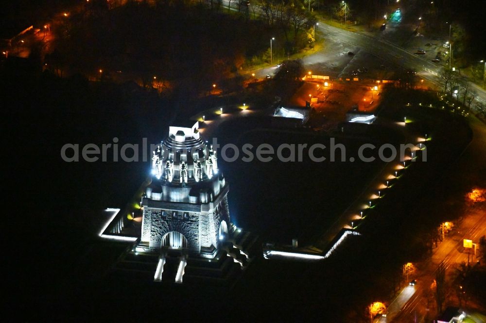 Aerial image at night Leipzig - Night lighting Tourist attraction of the historic monument Voelkerschlachtdenkmal on Strasse of 18. Oktober in Leipzig in the state Saxony, Germany