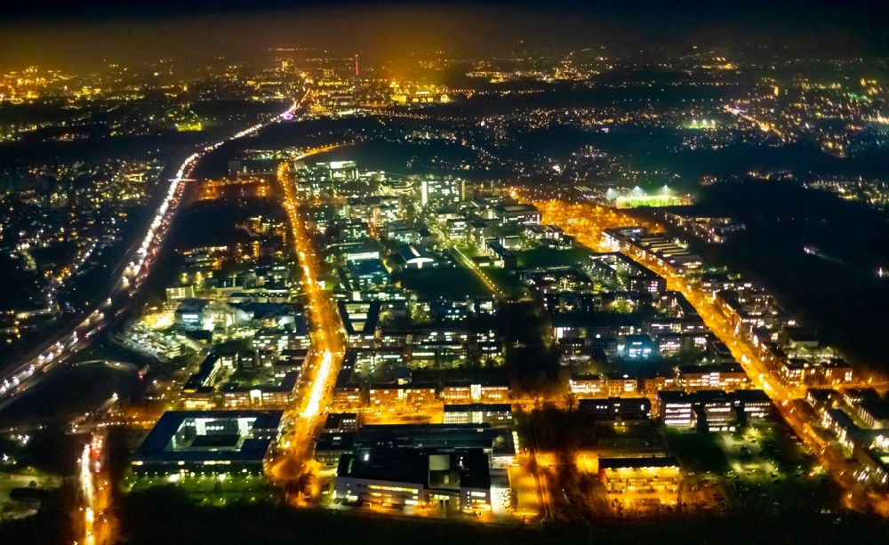 Dortmund at night from the bird perspective: Night lighting industrial park TechnologiePark Dortmund in Dortmund in the state North Rhine-Westphalia, Germany