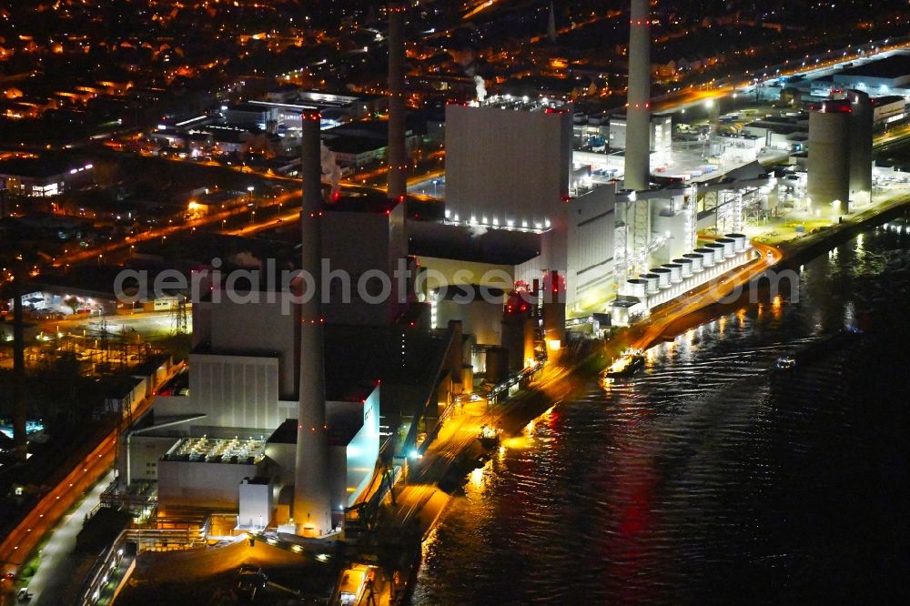 Mannheim at night from above - Night lighting power plants and exhaust towers of coal thermal power station Grosskraftwerk Mannheim AG at the shore of the Rhine river near Neckarau on street Plinaustrasse in Mannheim in the state Baden-Wurttemberg, Germany