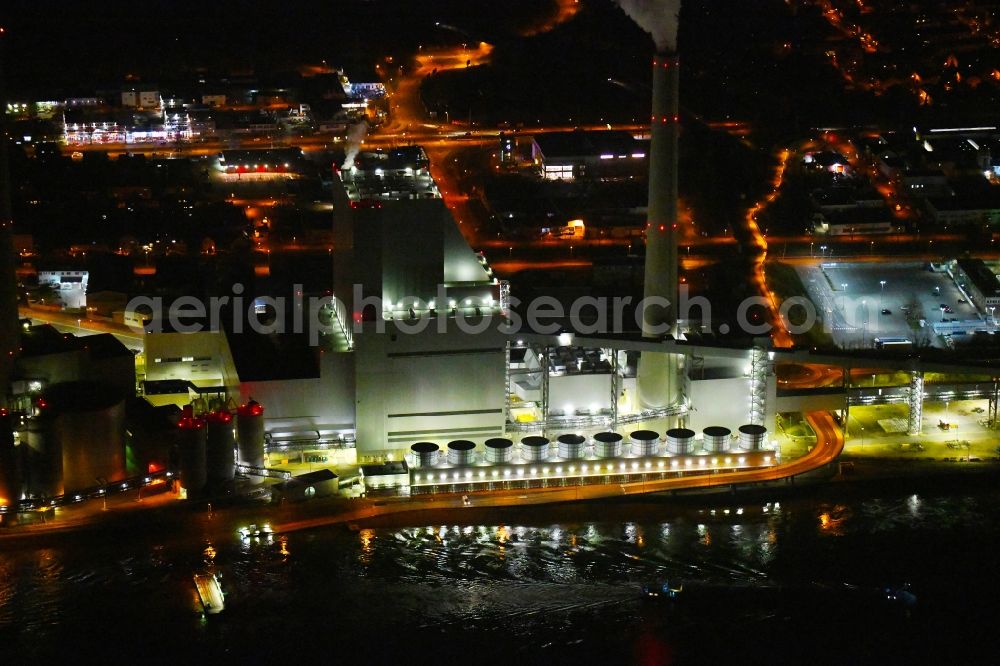 Mannheim at night from above - Night lighting power plants and exhaust towers of coal thermal power station Grosskraftwerk Mannheim AG at the shore of the Rhine river near Neckarau on street Plinaustrasse in Mannheim in the state Baden-Wurttemberg, Germany