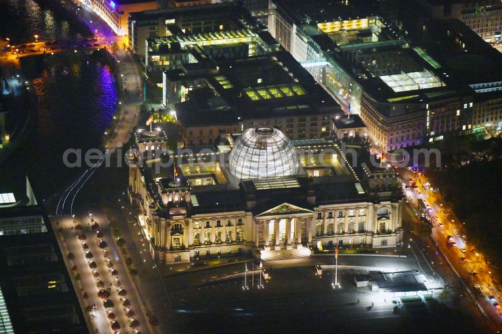 Aerial image at night Berlin - Night lighting Glass dome on the roof of Reichstag in Berlin on the Spree sheets in Berlin - Mitte