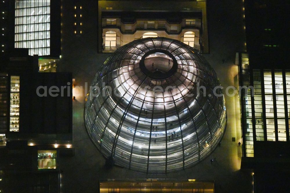 Aerial image at night Berlin - Night lighting Glass dome on the roof of Reichstag in Berlin on the Spree sheets in Berlin - Mitte