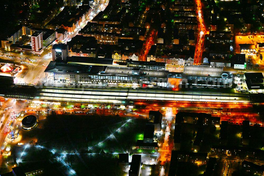 Aerial image at night Berlin - Night lighting tracks of the Spandau S-Bahn station and the Spandau Arcaden shopping centre on Klosterstrasse in the Spandau district of Berlin, Germany