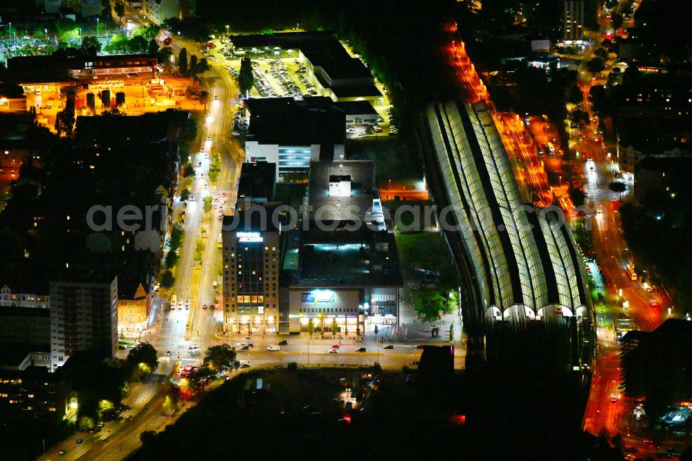 Aerial image at night Berlin - Night lighting tracks of the Spandau S-Bahn station and the Spandau Arcaden shopping centre on Klosterstrasse in the Spandau district of Berlin, Germany