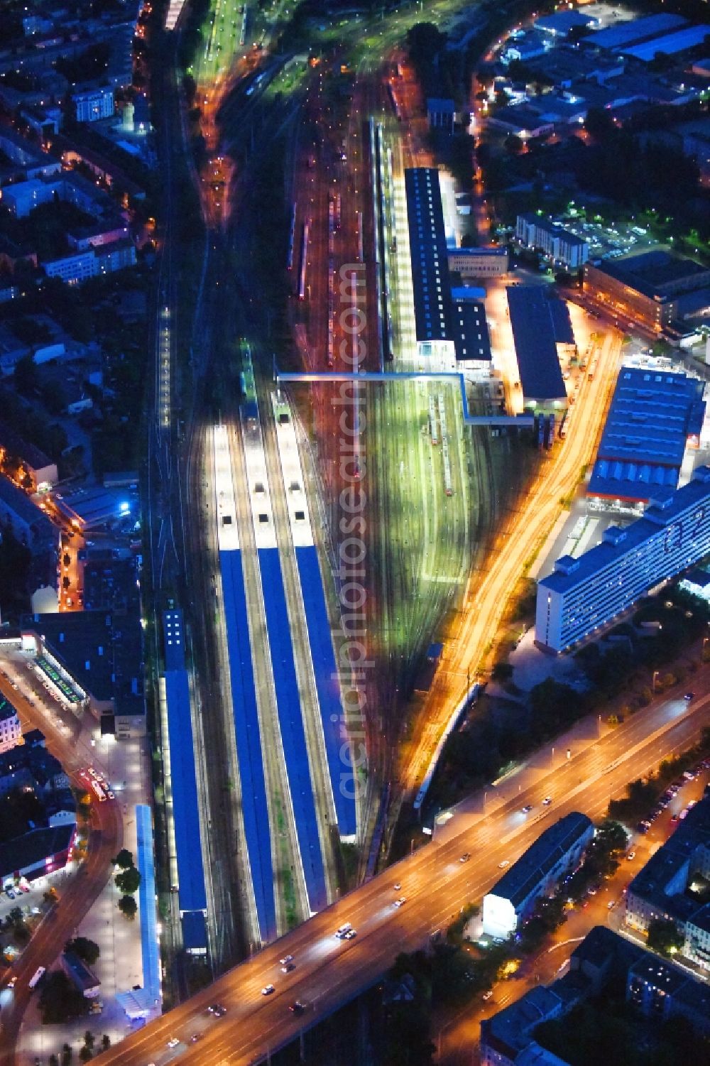 Aerial image at night Berlin - Night lighting Railway tracks and platforms of the station Lichtenberg in Berlin