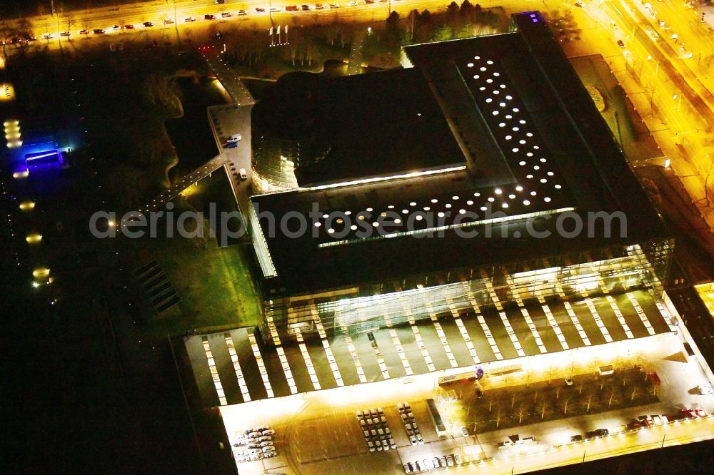 Aerial image at night Dresden - Night lighting vW transparent factory in Dresden in Saxony. The transparent factory is a Dresden automobile factory of Volkswagen AG, which is operated by the Volkswagen Sachsen GmbH