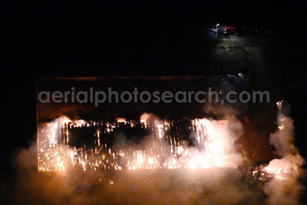 Bad Lauchstädt at night from above - Night lighting fire controlled by the fire brigade - major fire in a straw bale silage bale stack on an agricultural storage area on the country road L173 in Bad Lauchstaedt in the state Saxony-Anhalt, Germany