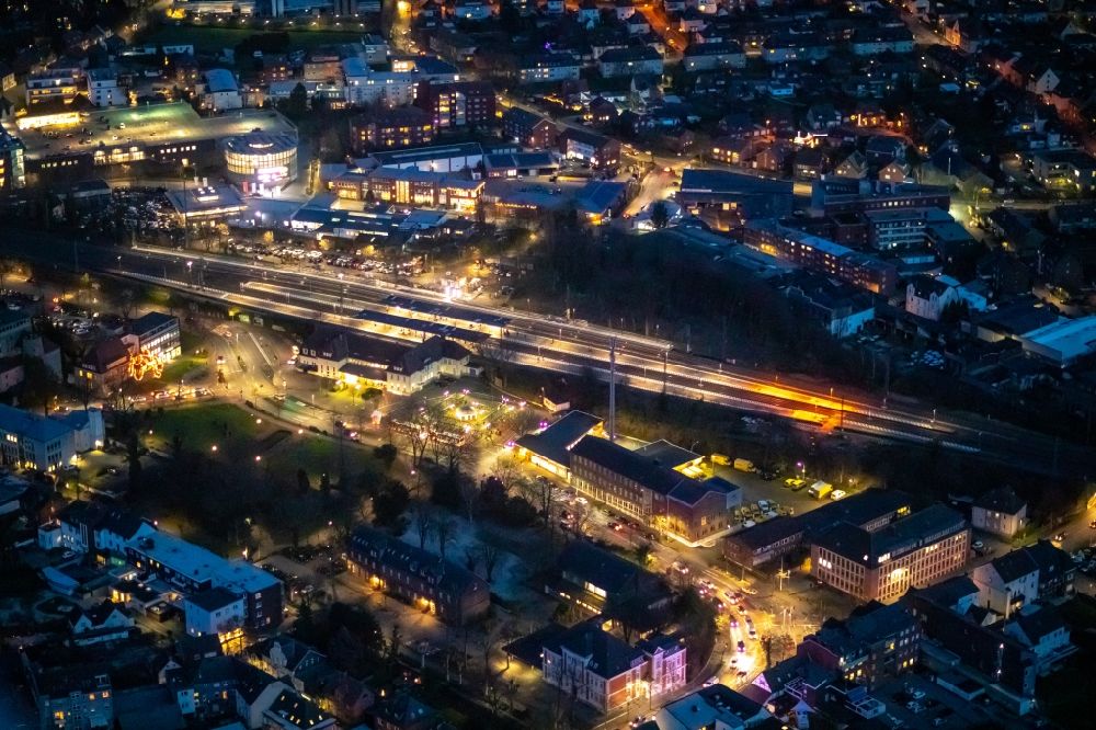 Aerial photograph at night Ahlen - Night lighting track progress and building of the main station of the railway in Ahlen in the state North Rhine-Westphalia, Germany