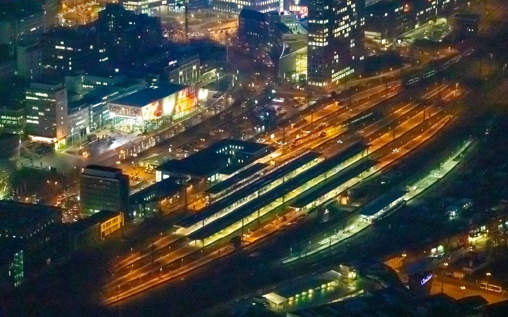 Aerial image at night Dortmund - Night lighting track progress and building of the main station of the railway in Dortmund in the state North Rhine-Westphalia, Germany