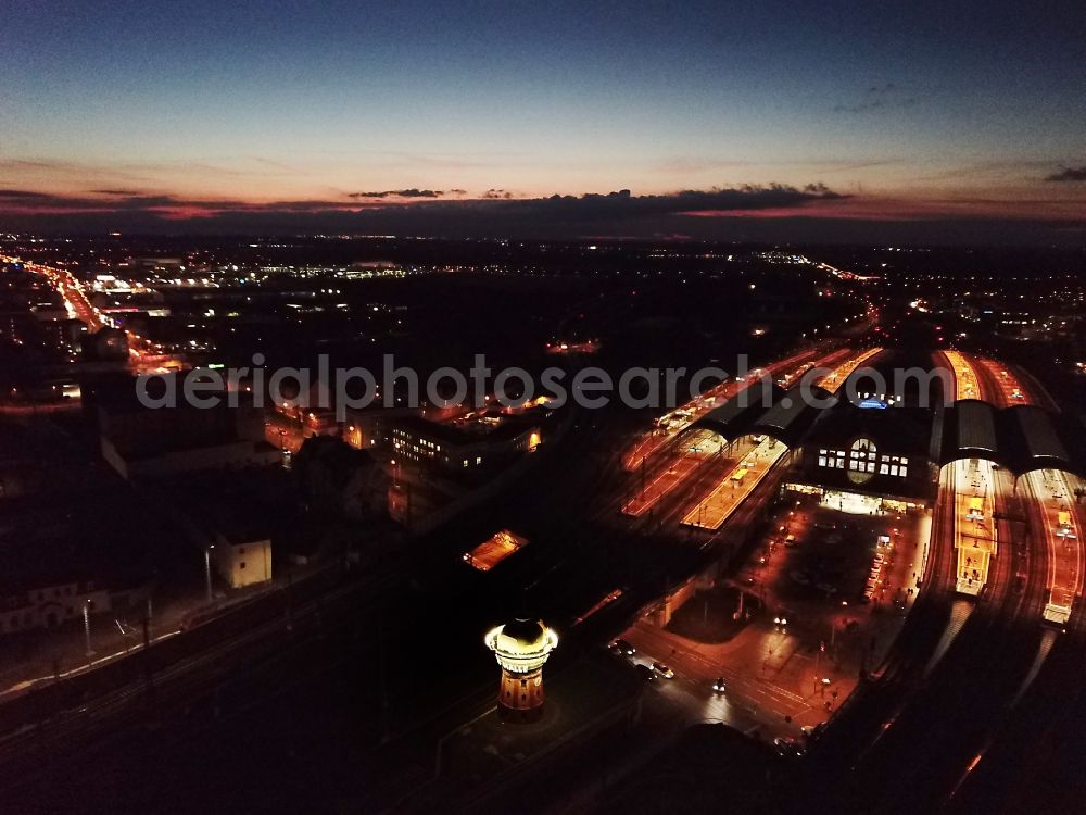 Aerial image at night Halle (Saale) - Night lighting track progress and building of the main station of the railway in Halle (Saale) in the state Saxony-Anhalt, Germany