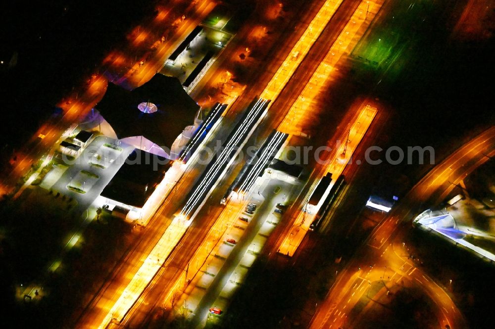 Aerial image at night Lutherstadt Wittenberg - Night lighting track progress and building of the main station of the railway in Lutherstadt Wittenberg in the state Saxony-Anhalt, Germany