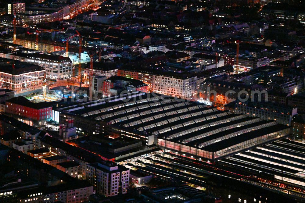 München at night from above - Night lighting track progress and building of the main station of the railway in Munich in the state Bavaria, Germany