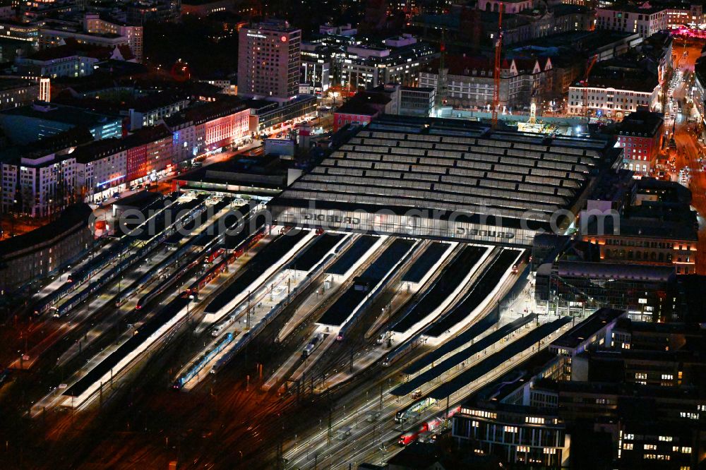 Aerial image at night München - Night lighting track progress and building of the main station of the railway in Munich in the state Bavaria, Germany