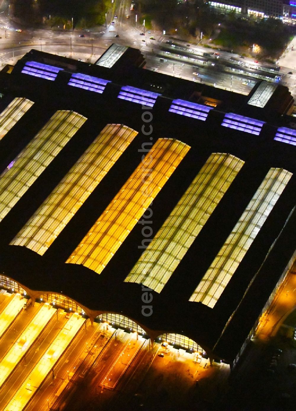 Leipzig at night from the bird perspective: Night lighting view over the building of the main station in Leipzig in Saxony
