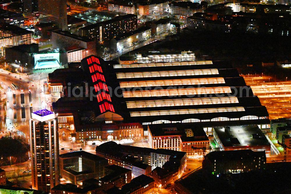 Aerial image at night Leipzig - Night lighting view over the building of the main station in the district Zentrum in Leipzig in Saxony