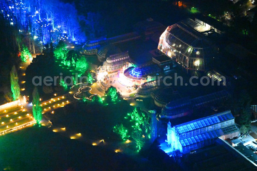 Berlin at night from above - Night lighting main building and greenhouse complex of the Botanical Gardens Berlin-Dahlem in Berlin. The historical glass buildings and greenhouses are dedicated to different areas. The Large Tropical House and the Victoria-House are located in the center