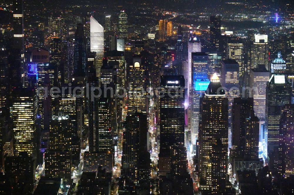 Aerial image at night New York - Night lighting High-rise ensemble in the district Manhattan in New York in United States of America