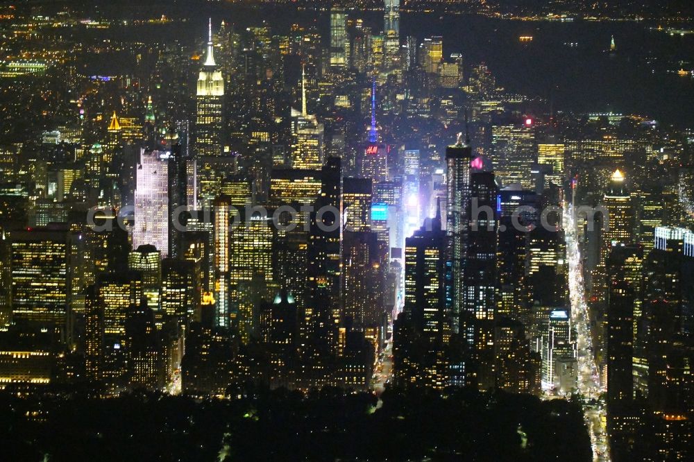 New York at night from the bird perspective: Night lighting High-rise ensemble in the district Manhattan in New York in United States of America