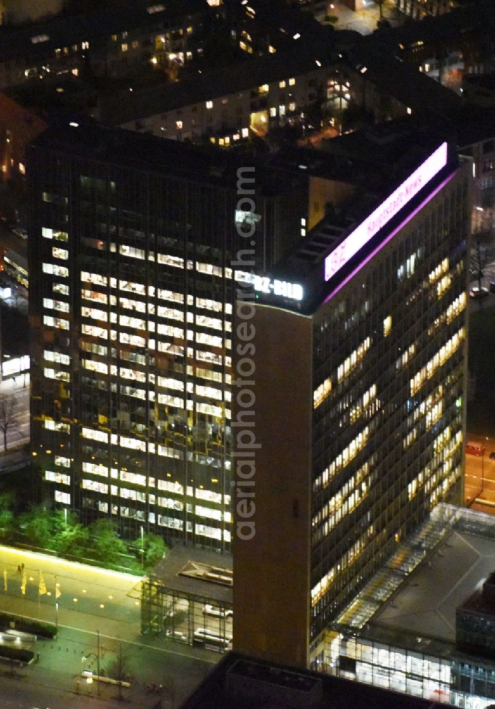 Aerial photograph at night Berlin - Night lighting Office and corporate management high-rise building of Axel-Springer Verlages on street Rudi- Dutschke- Strasse - Axel- Springer- Strasse in the district Kreuzberg in Berlin, Germany