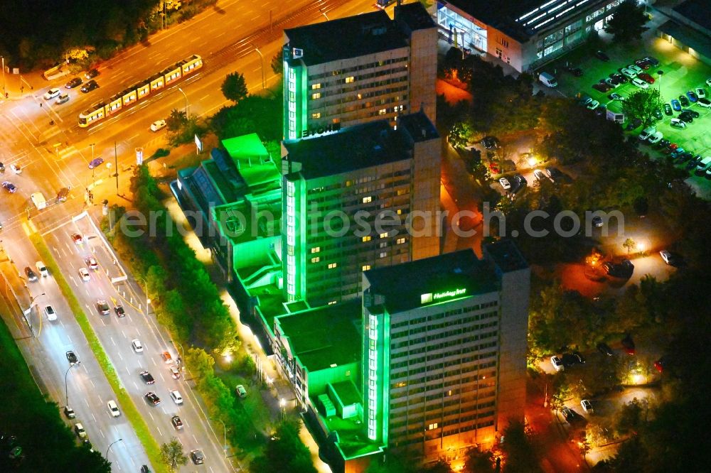 Aerial photograph at night Berlin - Night lighting High-rise building of the hotel complex Holiday Inn Berlin City East on Landsberger Allee in the district Lichtenberg in Berlin, Germany