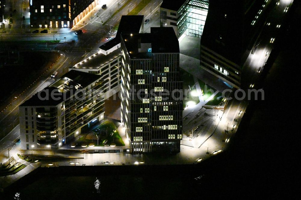 Aerial photograph at night Hamburg - Night lighting office and commercial building WATERMARK, Intelligent Quarters und Universitaet Hamburg in the Hafen City in Hamburg, Germany
