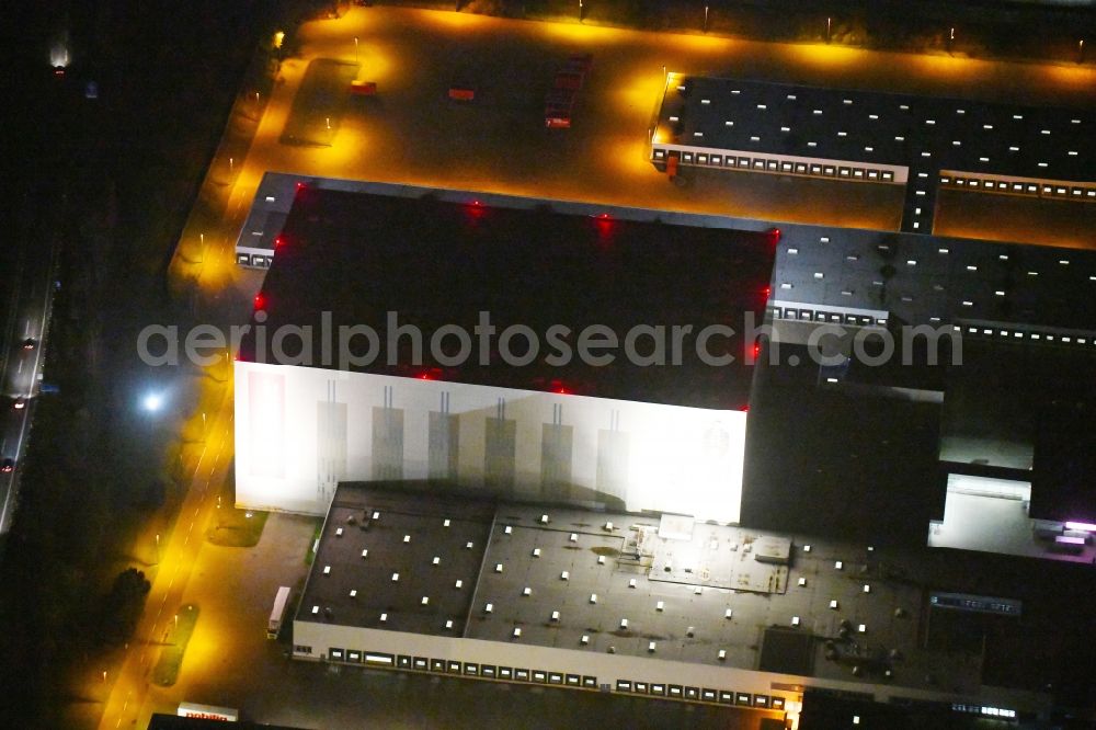 Schönefeld at night from above - Night lighting High-bay warehouse building complex and logistics center on the premises of Hoeffner Moebelgesellschaft GmbH & Co. KG Am Rondell in the district Waltersdorf in Schoenefeld in the state Brandenburg, Germany