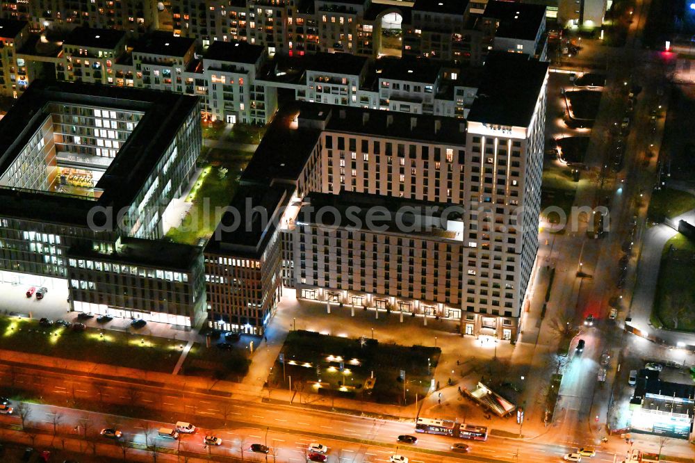 München at night from the bird perspective: Night lighting hotel complex H2 Hotel Muenchen Olympiapark on Moosacher Strasse in the district Milbertshofen-Am Hart in Munich in the state Bavaria, Germany