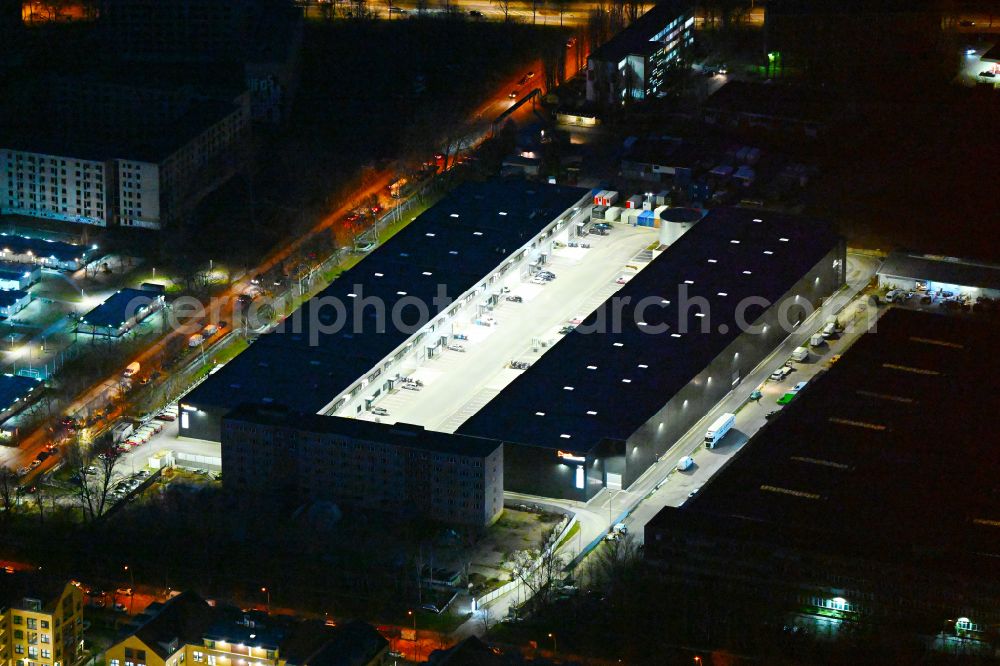 Aerial image at night Berlin - Night lighting industrial and commercial area on street Wollenberger Strasse in the district Hohenschoenhausen in Berlin, Germany