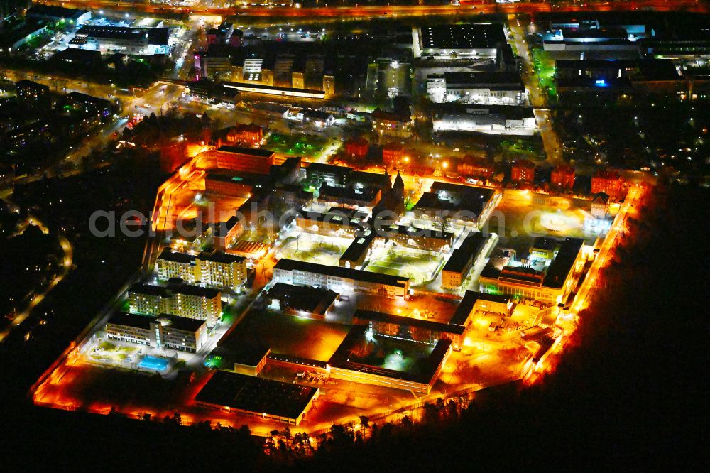 Aerial photograph at night Berlin - Night lighting prison grounds and high security fence Prison Tegel on Seidelstrasse in the district Reinickendorf in Berlin, Germany