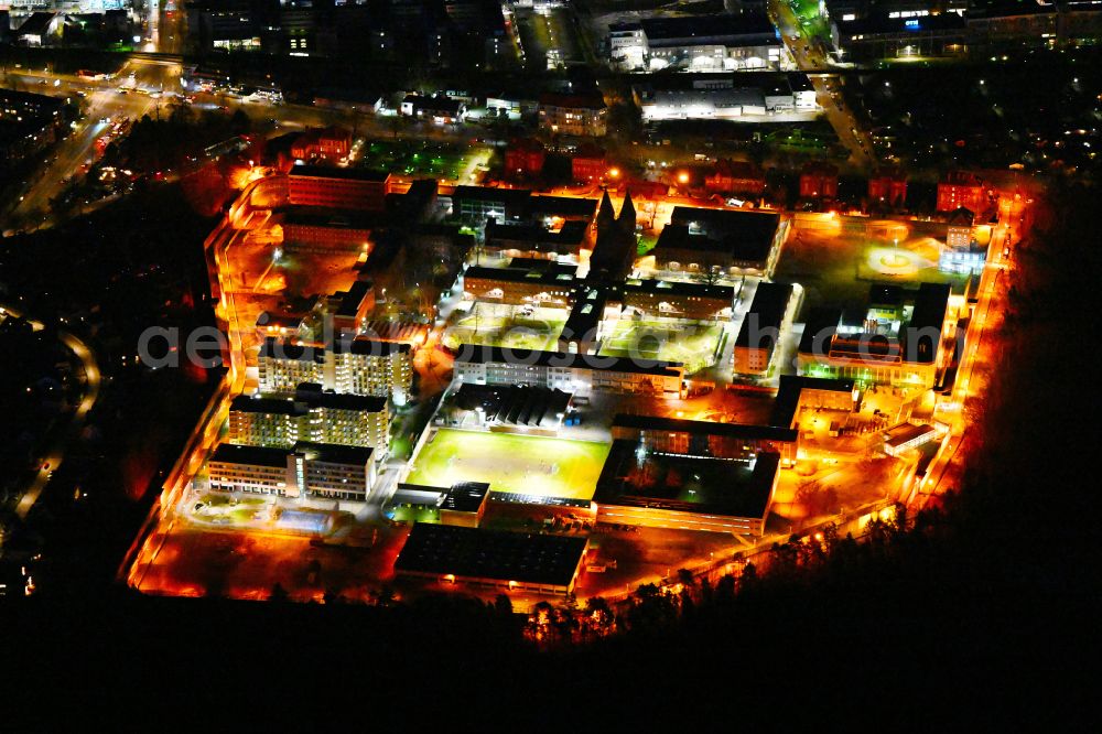 Aerial photograph at night Berlin - Night lighting prison grounds and high security fence Prison Tegel on Seidelstrasse in the district Reinickendorf in Berlin, Germany