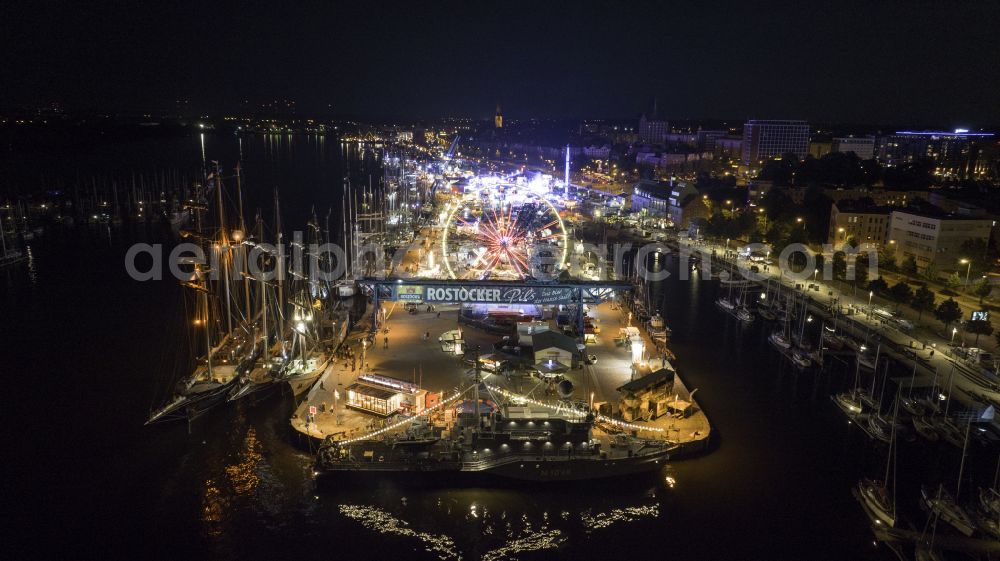 Aerial photograph at night Rostock - Night lighting ship moorings at the inland harbor basin on the banks of of Unterwarnow on street Haedgehafen in the district Stadtmitte in Rostock at the baltic sea coast in the state Mecklenburg - Western Pomerania, Germany