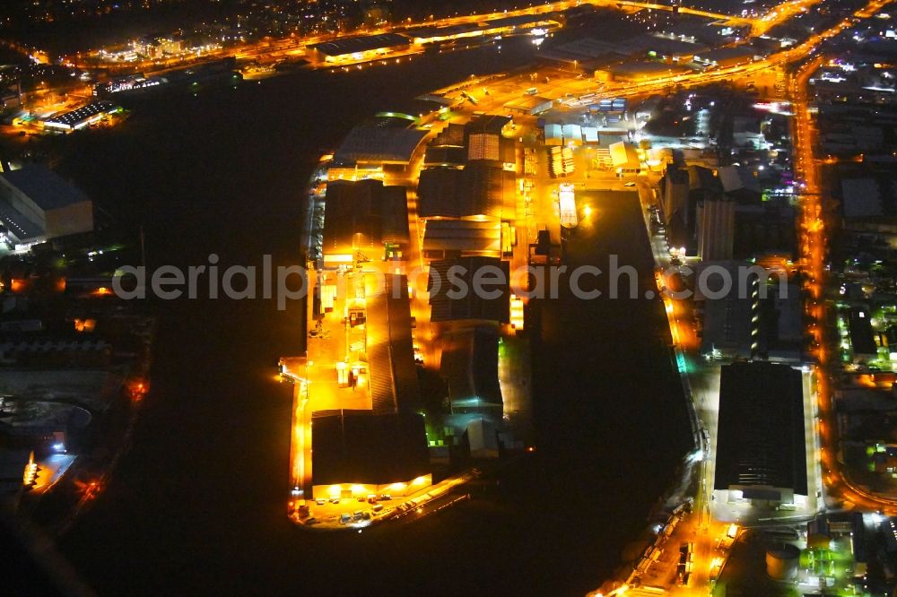 Aerial image at night Lübeck - Night lighting quays and boat moorings at the port of the inland port on shore of Trave in the district Falkenfeld - Vorwerk in Luebeck in the state Schleswig-Holstein, Germany