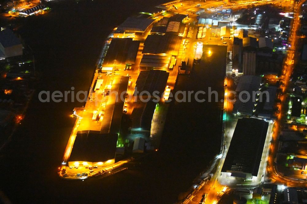 Lübeck at night from above - Night lighting quays and boat moorings at the port of the inland port on shore of Trave in the district Falkenfeld - Vorwerk in Luebeck in the state Schleswig-Holstein, Germany