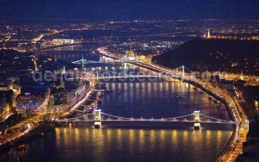 Aerial image at night Budapest - Night lighting river - Bridge structure of the chain bridge Szechenyi Lanchid over the course of the Danube in Budapest in Hungary