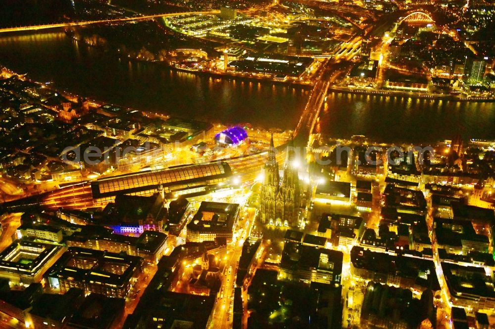 Aerial photograph at night Köln - Night lighting church building of the cathedral on train station in the old town along the Rhine river in Cologne in the state North Rhine-Westphalia, Germany