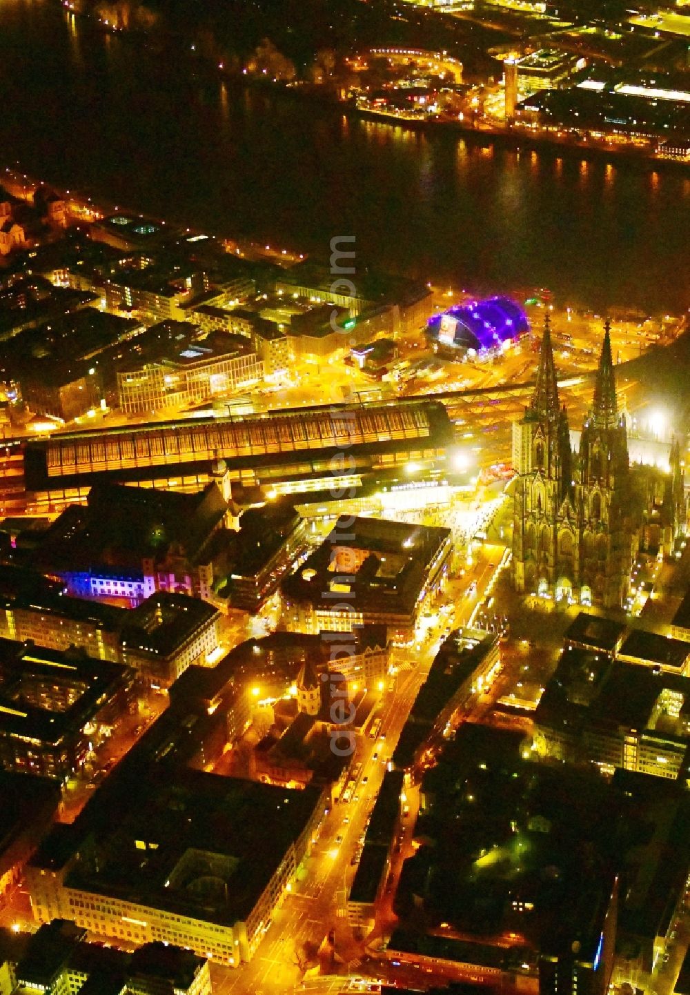 Aerial image at night Köln - Night lighting church building of the cathedral on train station in the old town along the Rhine river in Cologne in the state North Rhine-Westphalia, Germany