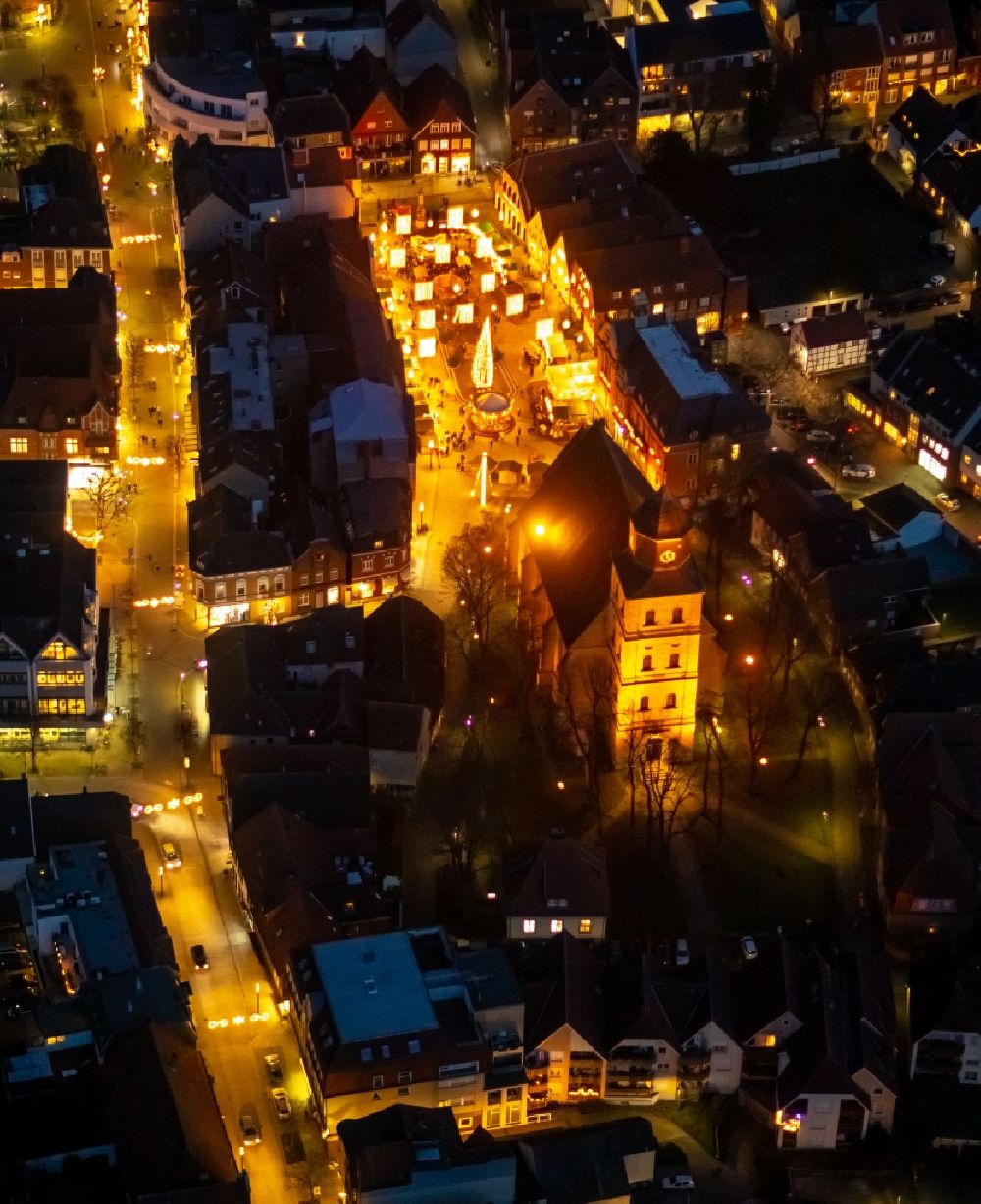 Aerial photograph at night Ahlen - Night lighting church building of the Catholic parish of St. Bartholomew in the old city center of the city center in Ahlen in the federal state of North Rhine-Westphalia, Germany
