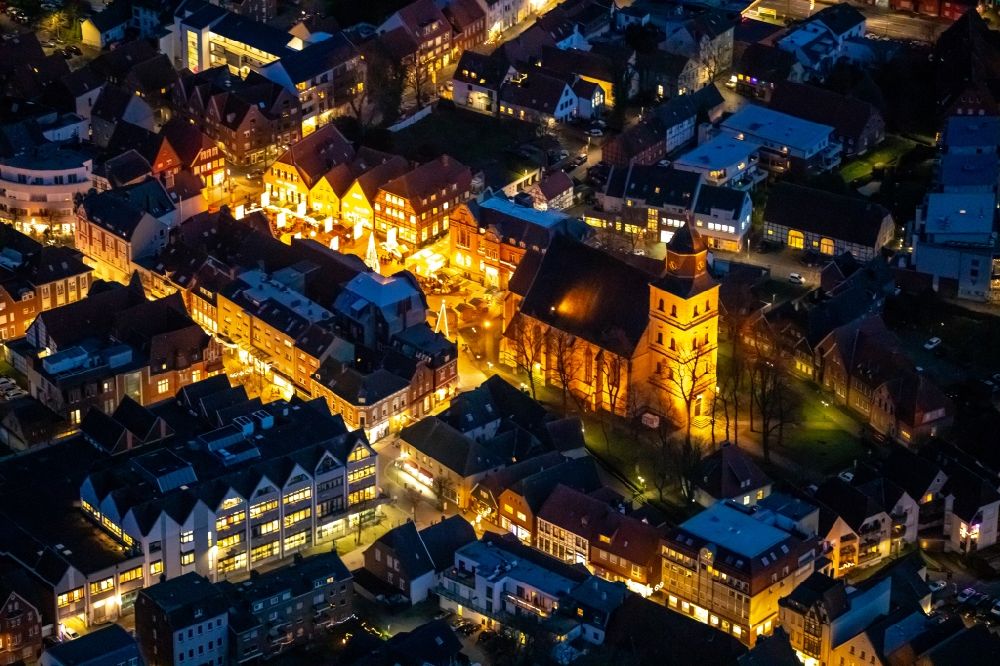 Aerial image at night Ahlen - Night lighting church building of the Catholic parish of St. Bartholomew in the old city center of the city center in Ahlen in the federal state of North Rhine-Westphalia, Germany