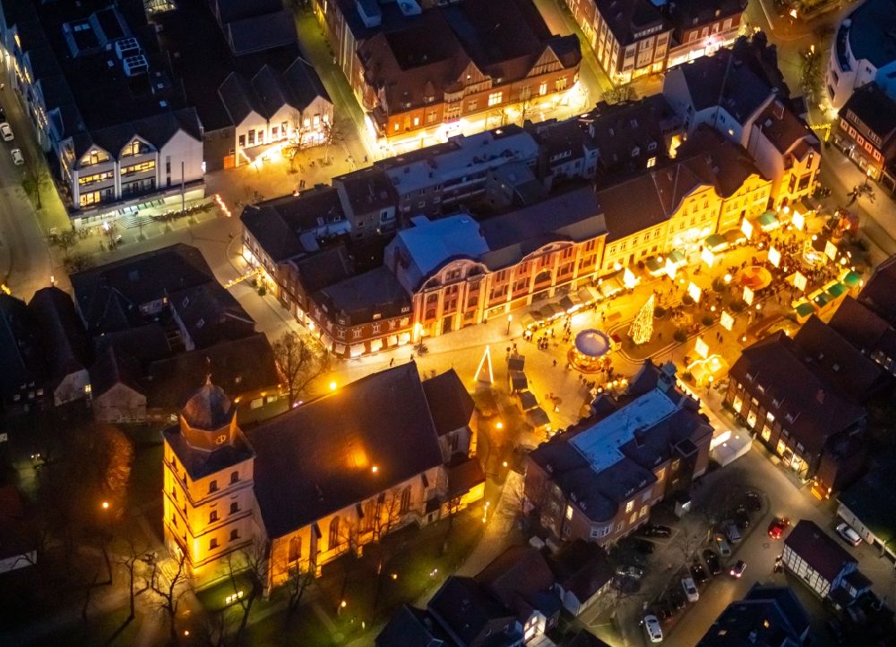 Ahlen at night from the bird perspective: Night lighting church building of the Catholic parish of St. Bartholomew in the old city center of the city center in Ahlen in the federal state of North Rhine-Westphalia, Germany