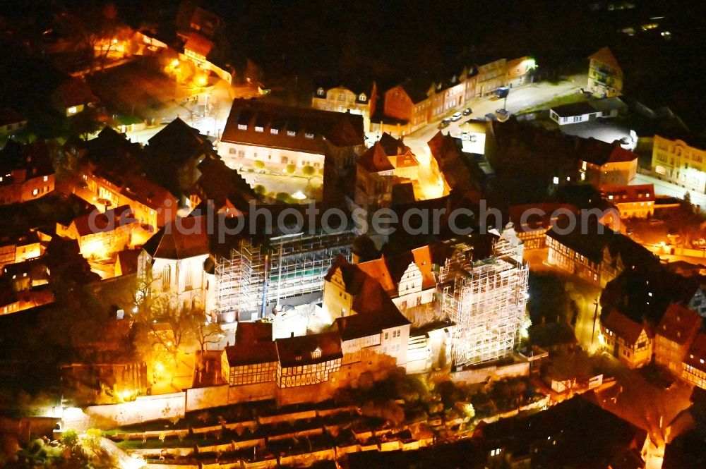 Aerial photograph at night Quedlinburg - Night lighting church building in of Stiftskirche Schlosskirche - St.Servatii on Schlossberg Old Town- center of downtown in Quedlinburg in the state Saxony-Anhalt, Germany