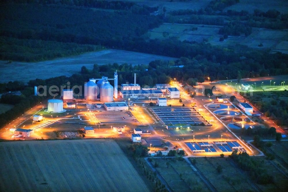 Aerial image at night Münchehofe - Night lighting sewage works Basin and purification steps for waste water treatment in Muenchehofe in the state Brandenburg, Germany