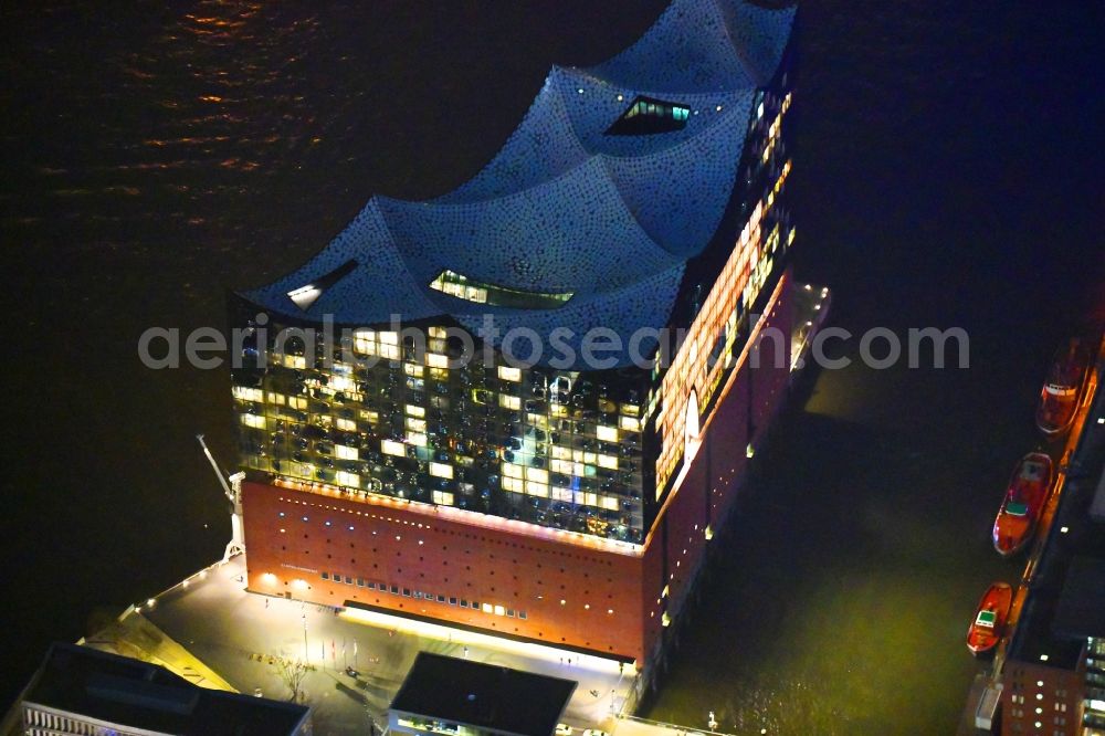 Hamburg at night from the bird perspective: Night lighting The Elbe Philharmonic Hall on the river bank of the Elbe in Hamburg