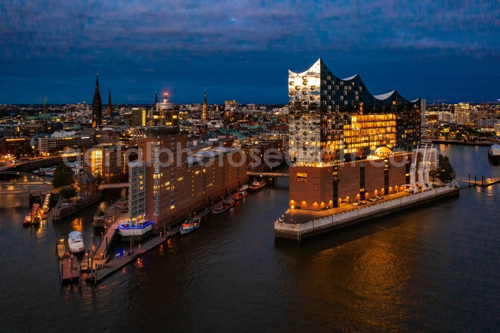 Aerial image at night Hamburg - Night lighting the Elbe Philharmonic Hall on the river bank of the Elbe in Hamburg